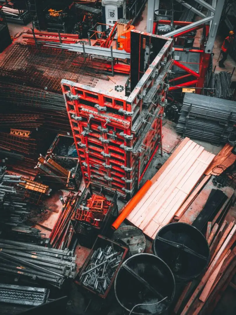 A bunch of red and black pallets in a warehouse