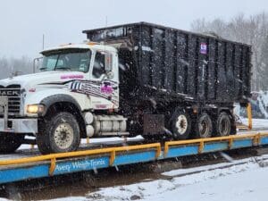 A large truck is on the trailer in the snow.
